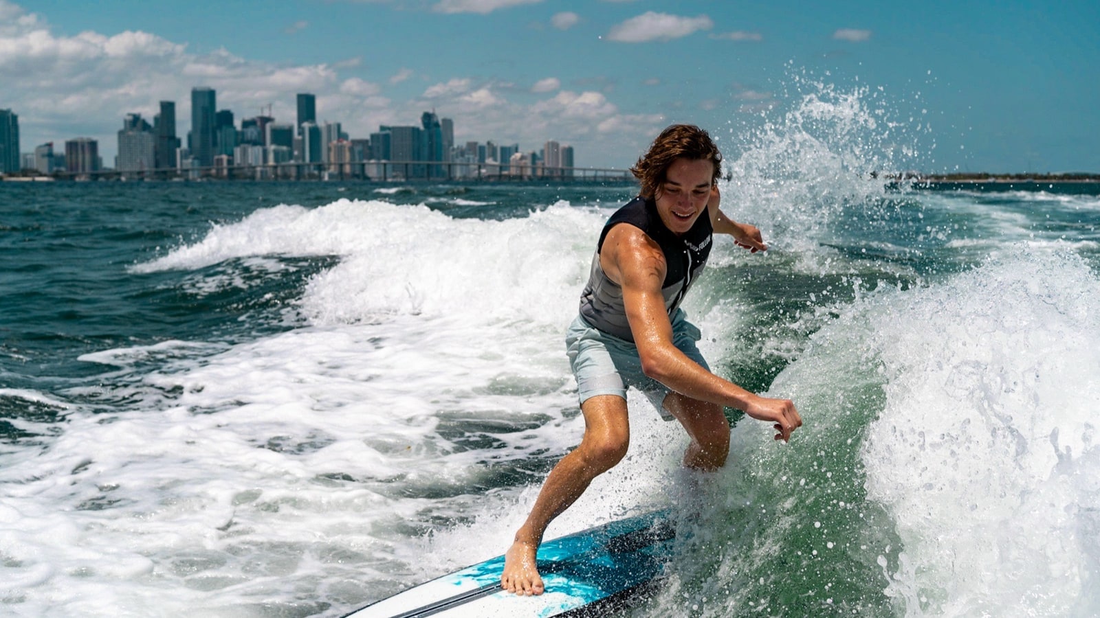 WakeXscape rider surfing with the Miami skyline beyond